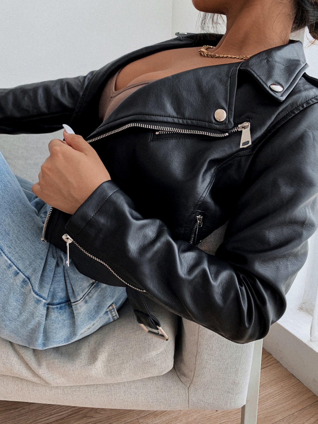 Leather jacket with notched collar, front zipper, and belt